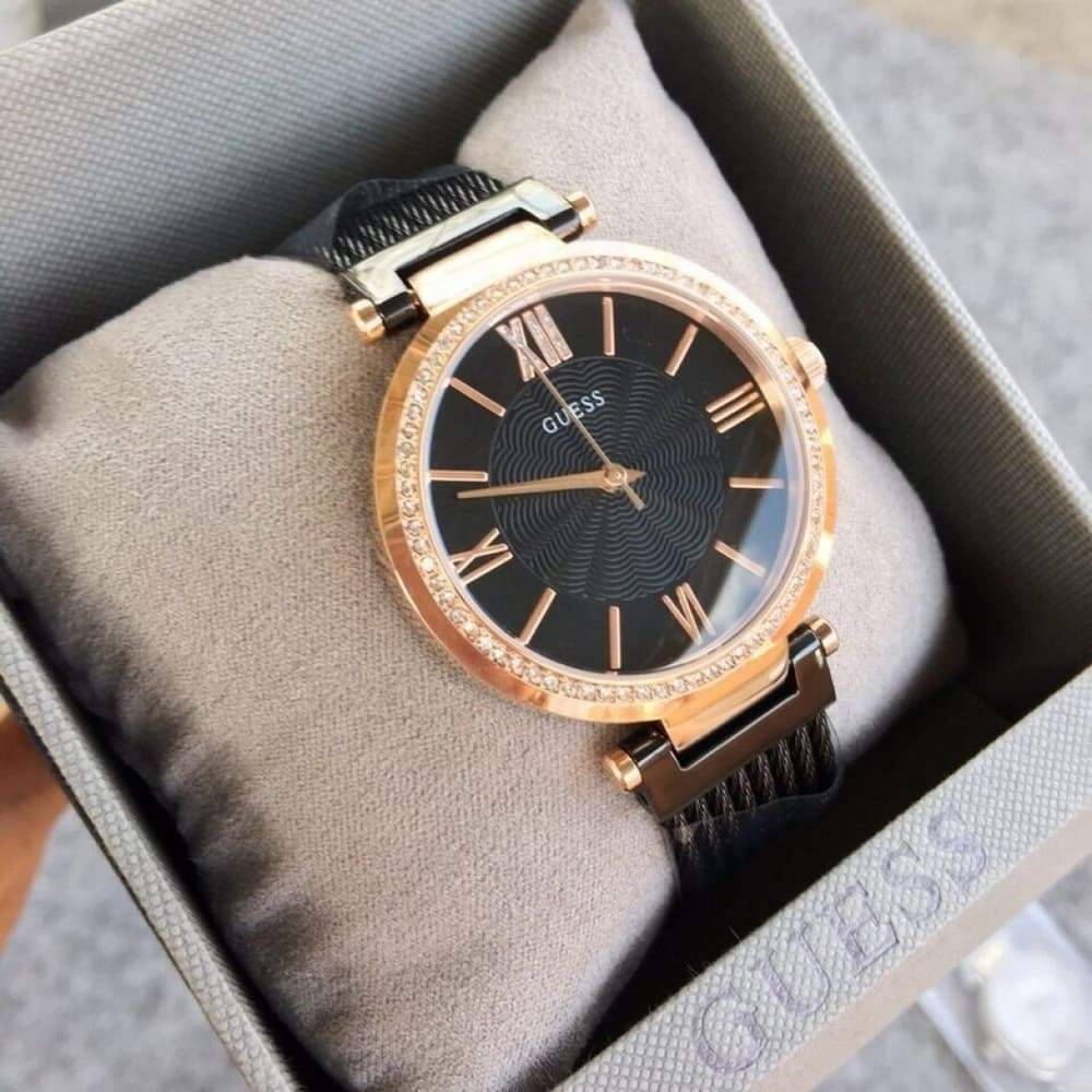 Guess W0638L5 watch displayed on beige pillow in branded box