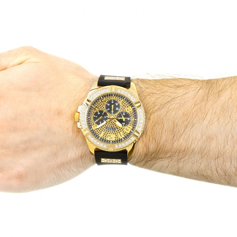 Gold tone chronograph watch with crystal bezel worn on male wrist