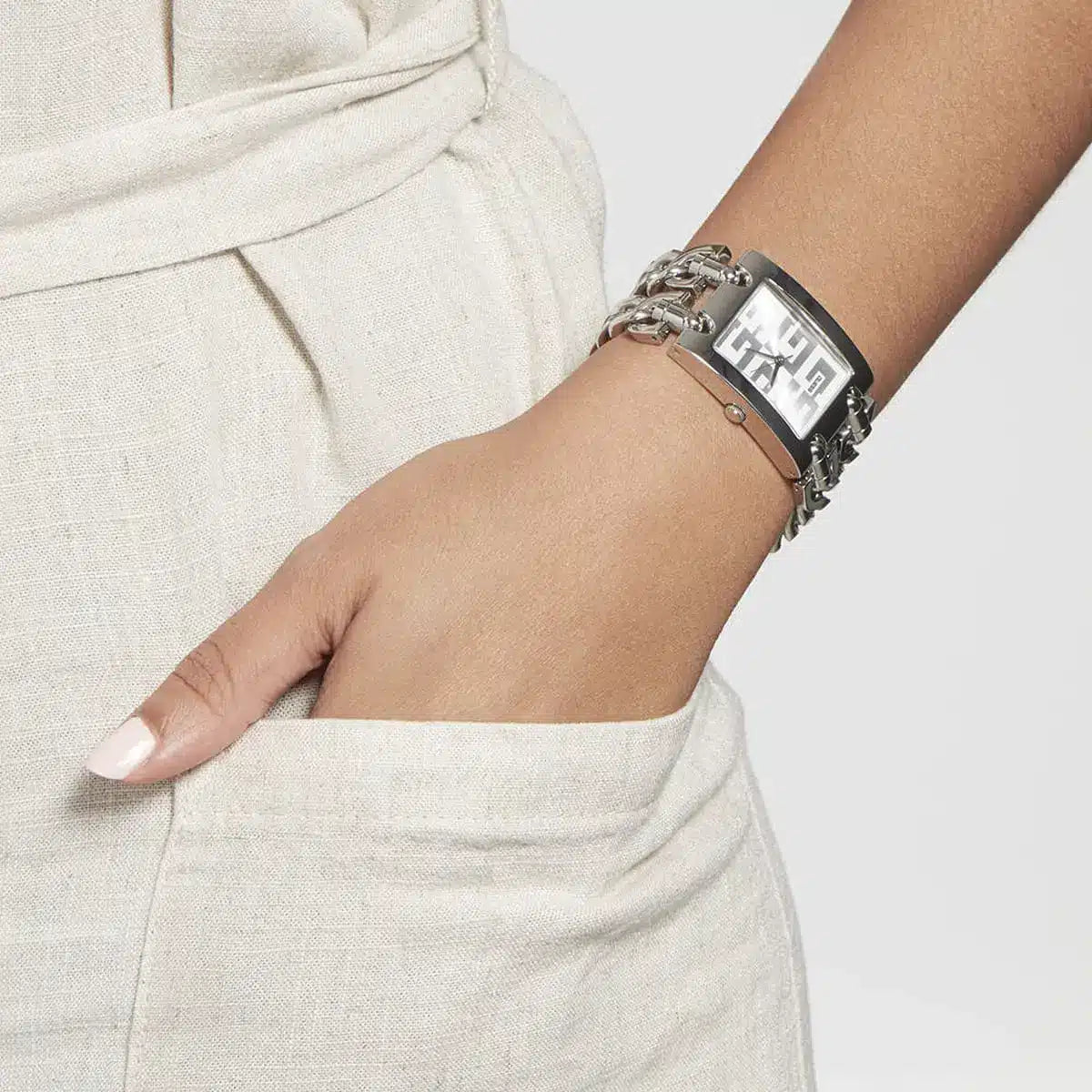 Guess MOD G square watch worn on wrist with silver chain bracelet and dial
