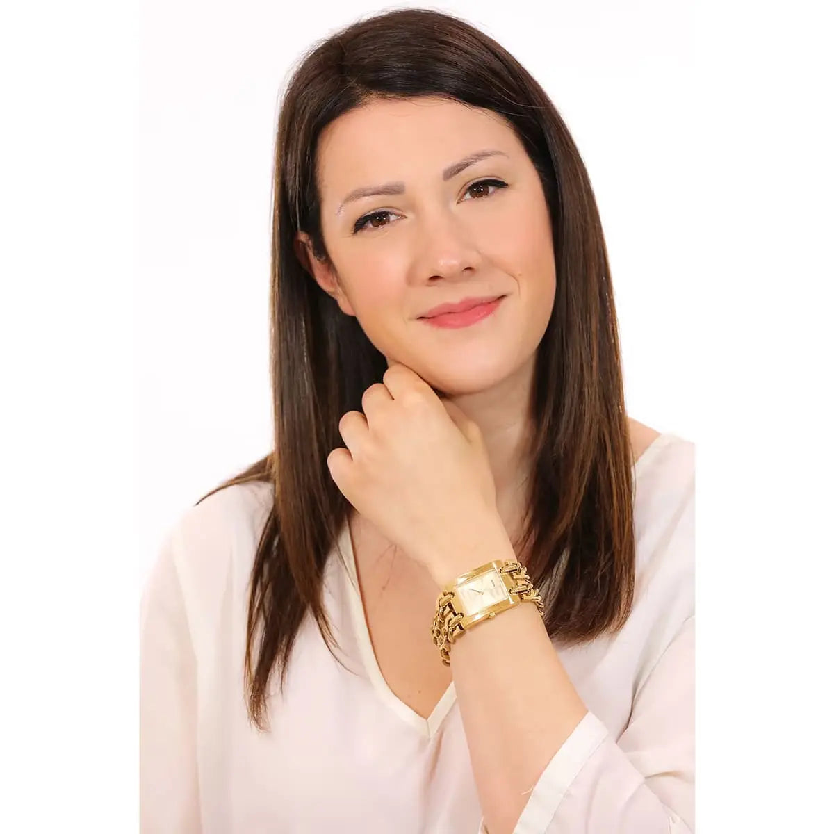 Woman wearing Guess G Mod gold rectangular watch