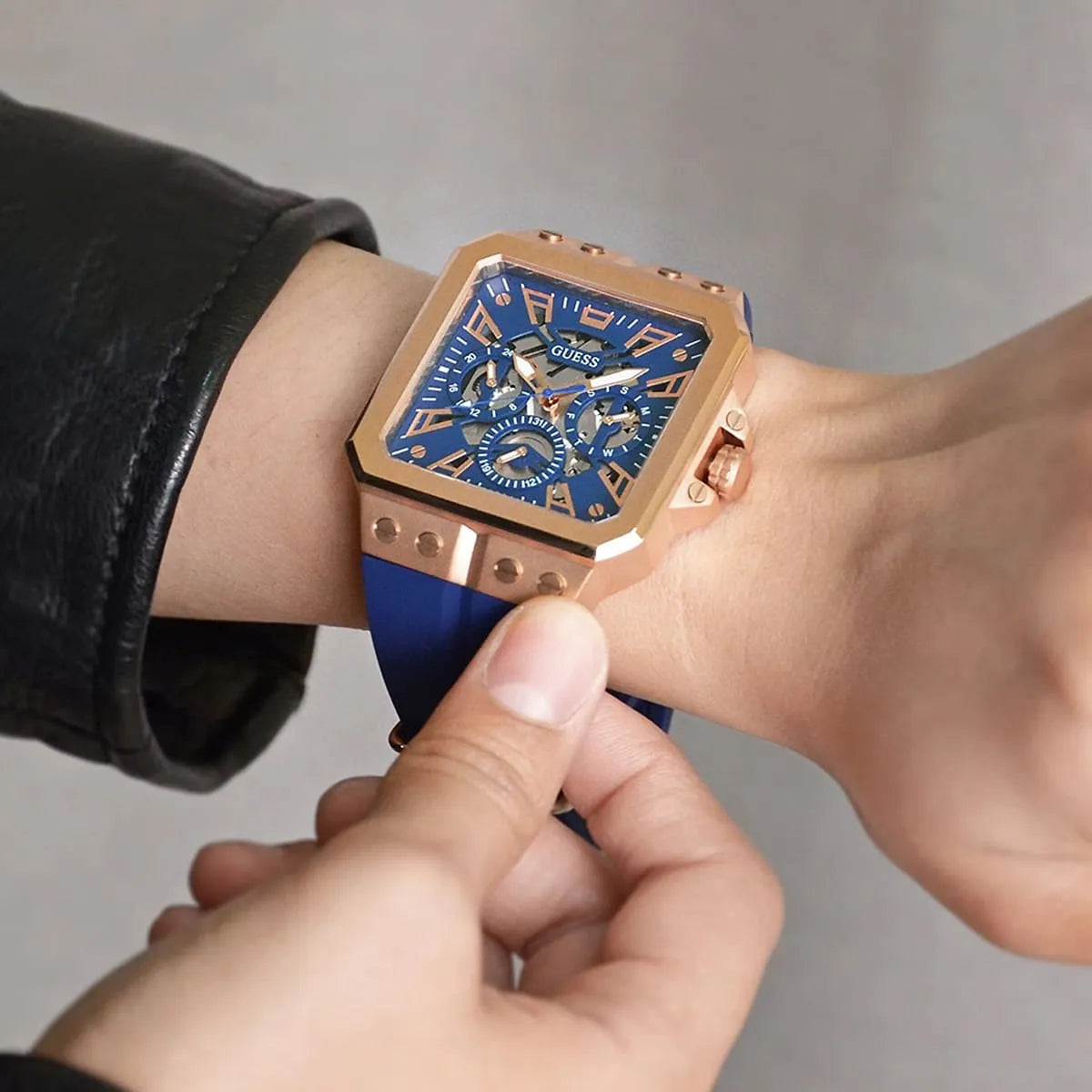 GUESS GW0637G3 on wrist showing blue dial and rose gold case with rubber strap