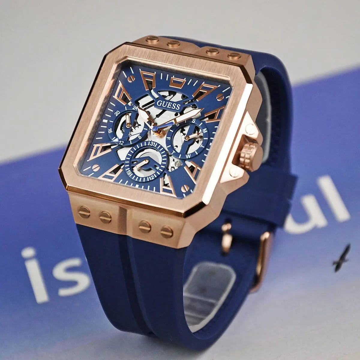 GUESS GW0637G3 worn on wrist with blue strap and rose gold square case visible