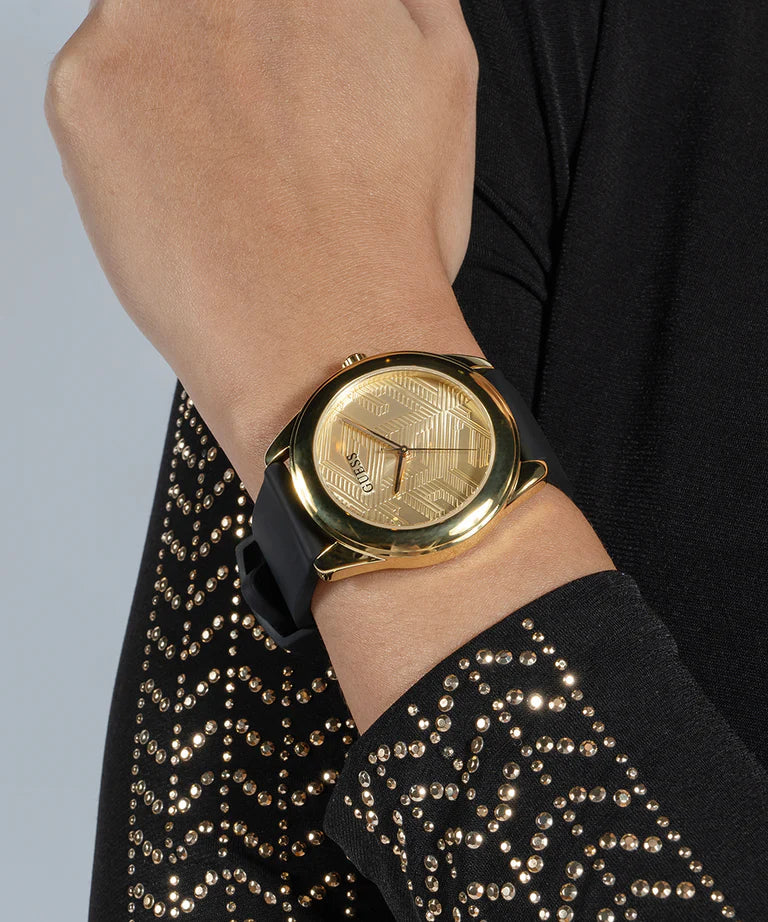 Guess Cubed GW0665L1 women's watch on wrist showing gold tone and black strap detail