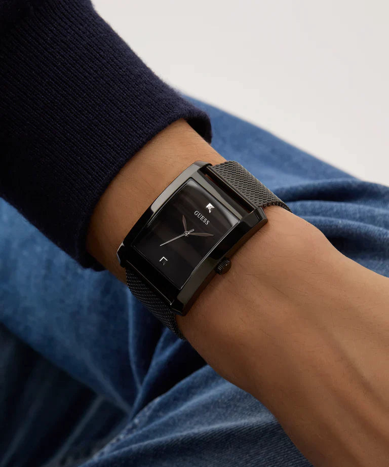 GUESS black watch worn on wrist with dark blue and light colored sleeve