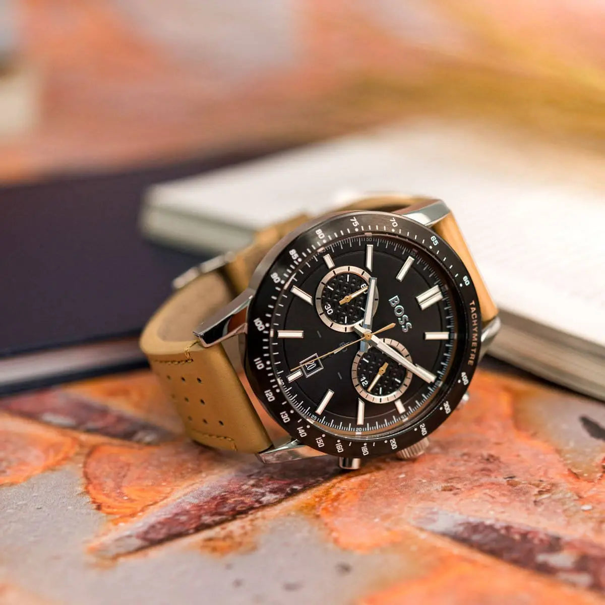Hugo Boss Allure chronograph watch on designer notebook with beige leather strap
