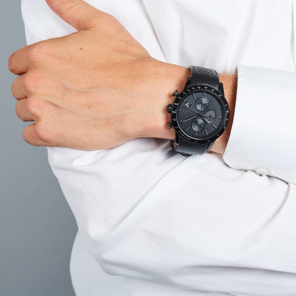Hugo Boss black dial chronograph watch on wrist with white shirt sleeve