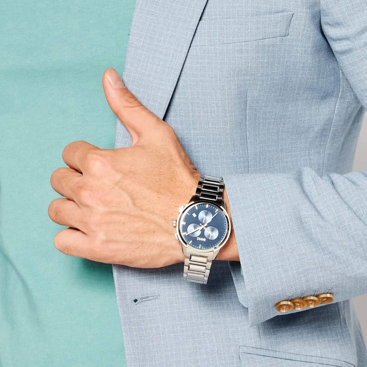 Hugo Boss Dapper chronograph watch worn on wrist with light blue suit jacket