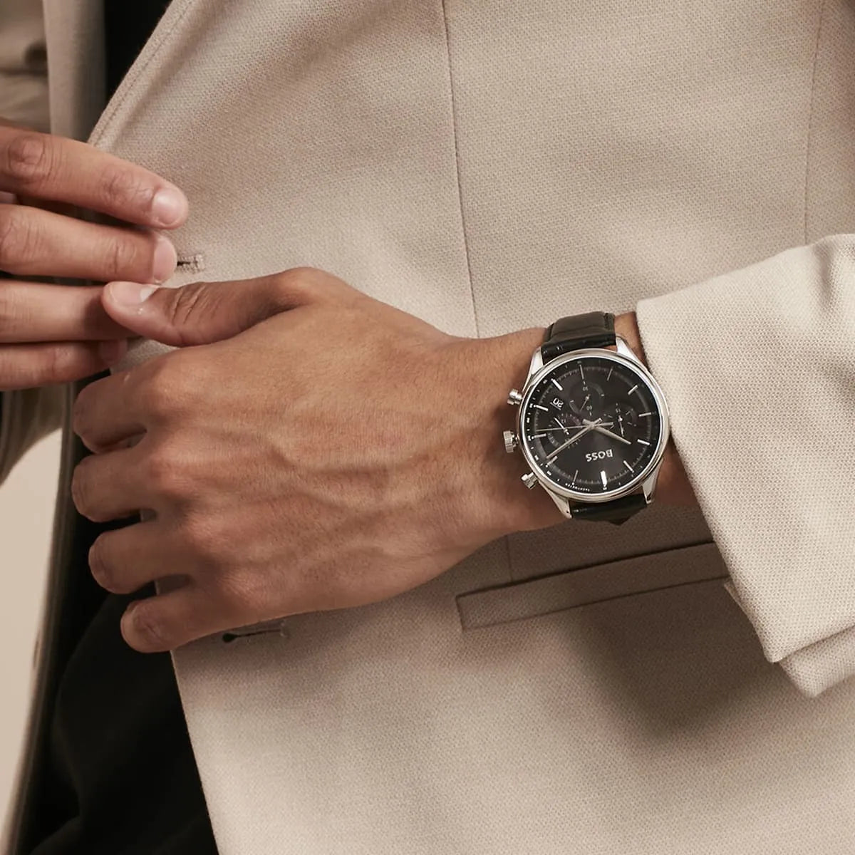 Hugo Boss Gregor watch on male wrist showing black dial and leather band