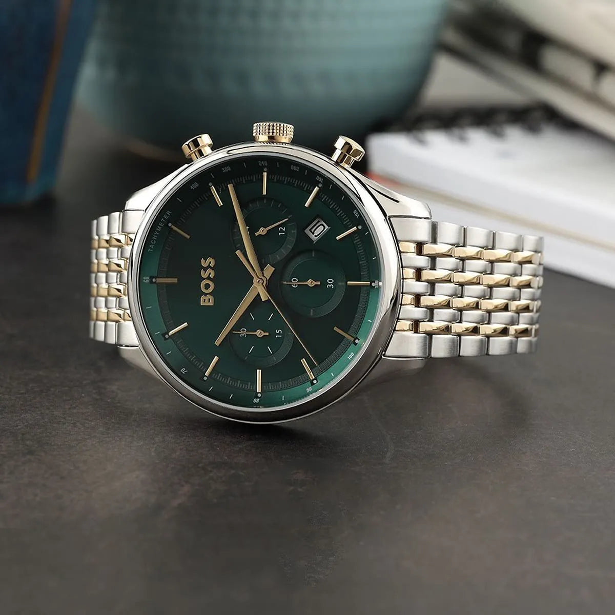 Hugo Boss Gregor chronograph watch on wrist showing green dial and two-tone bracelet