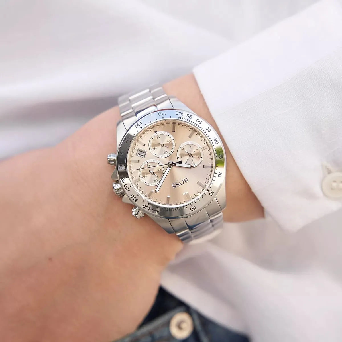 Hugo Boss Novia chronograph watch on woman's wrist, pink dial with silver bracelet