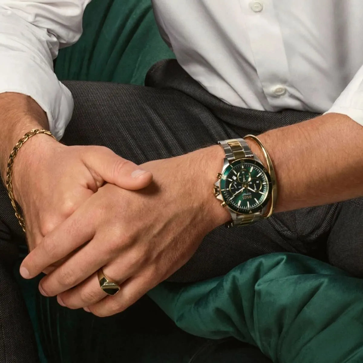 Hugo Boss Troper chronograph watch worn on wrist with green dial and matching two-tone bracelet