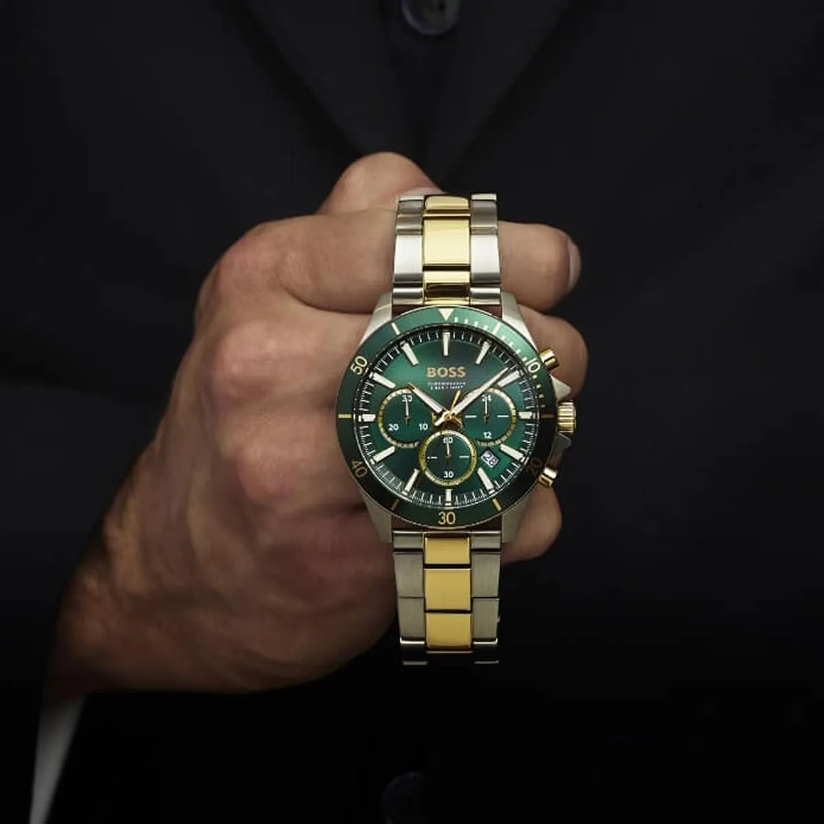 Hugo Boss Troper chronograph watch on wrist with green dial and two-tone metal bracelet