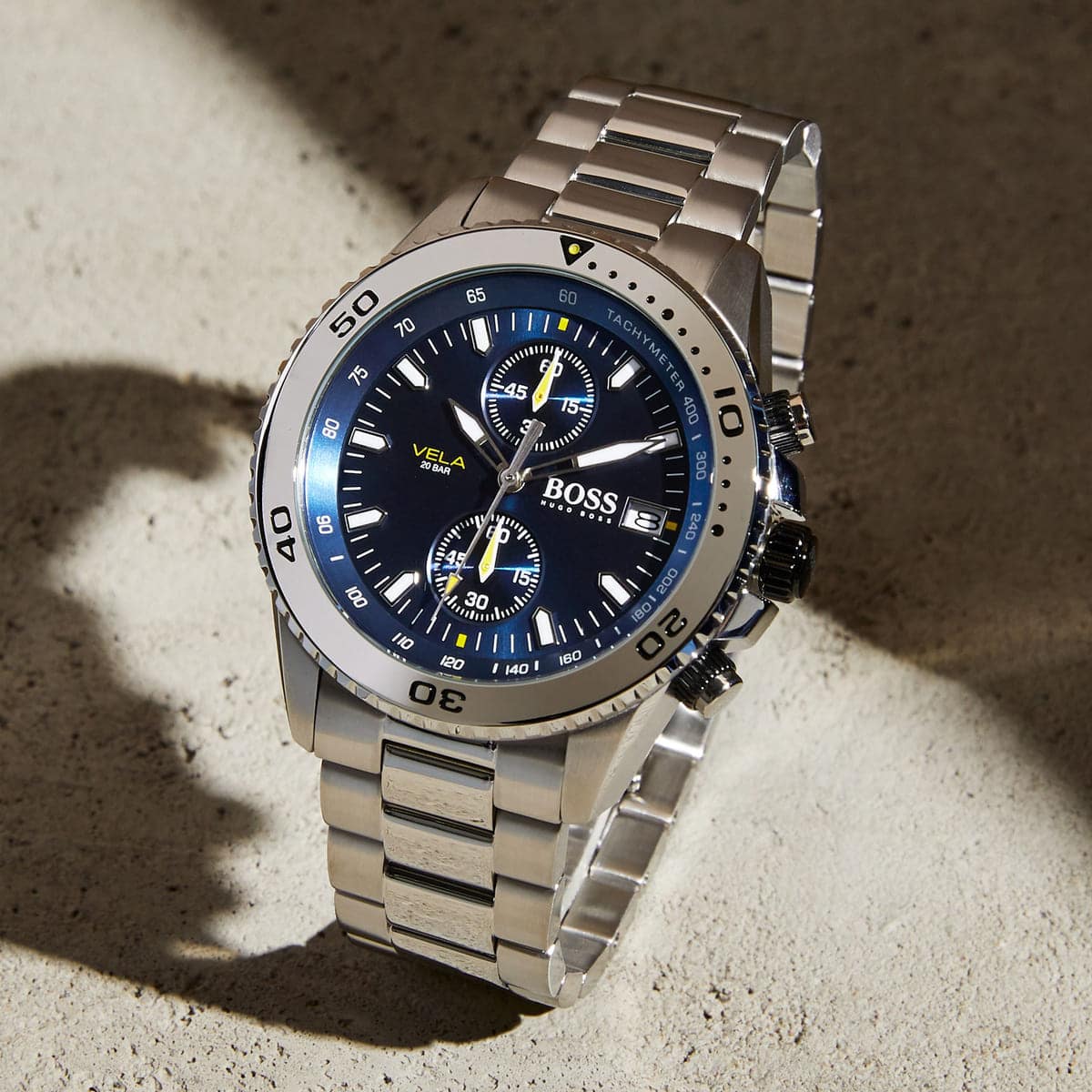 Hugo Boss Vela chronograph men's watch displayed on concrete surface with shadow