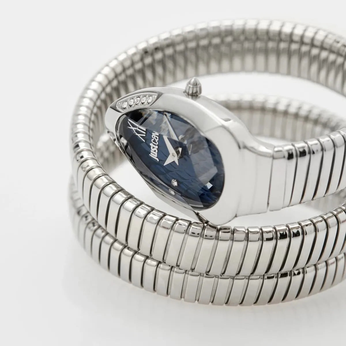 Close-up of Just Cavalli Serpente Metallica watch dial with blue face, Roman numerals, and silver case