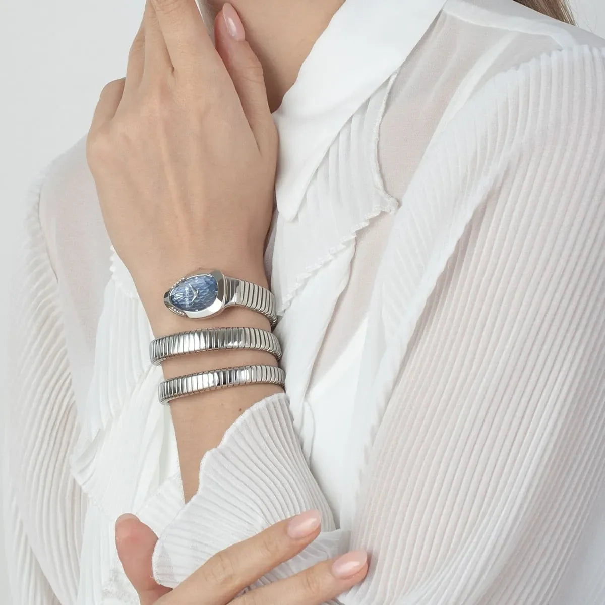 Just Cavalli Serpente Metallica watch on wrist showing blue dial and silver snake-texture strap detail