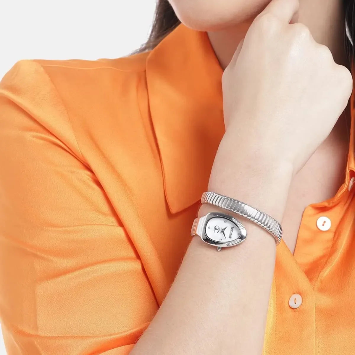 Just Cavalli silver watch worn on wrist with double-wrap snake-design bracelet strap