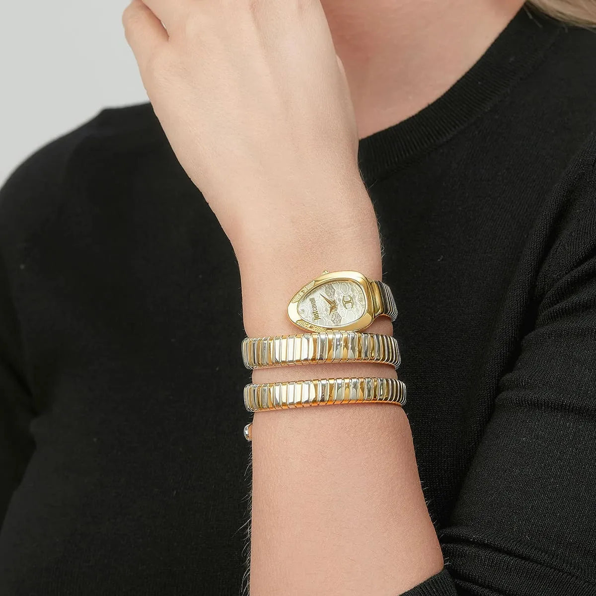 Just Cavalli Signature Snake women's watch worn on wrist with triple-wrap snake bracelet