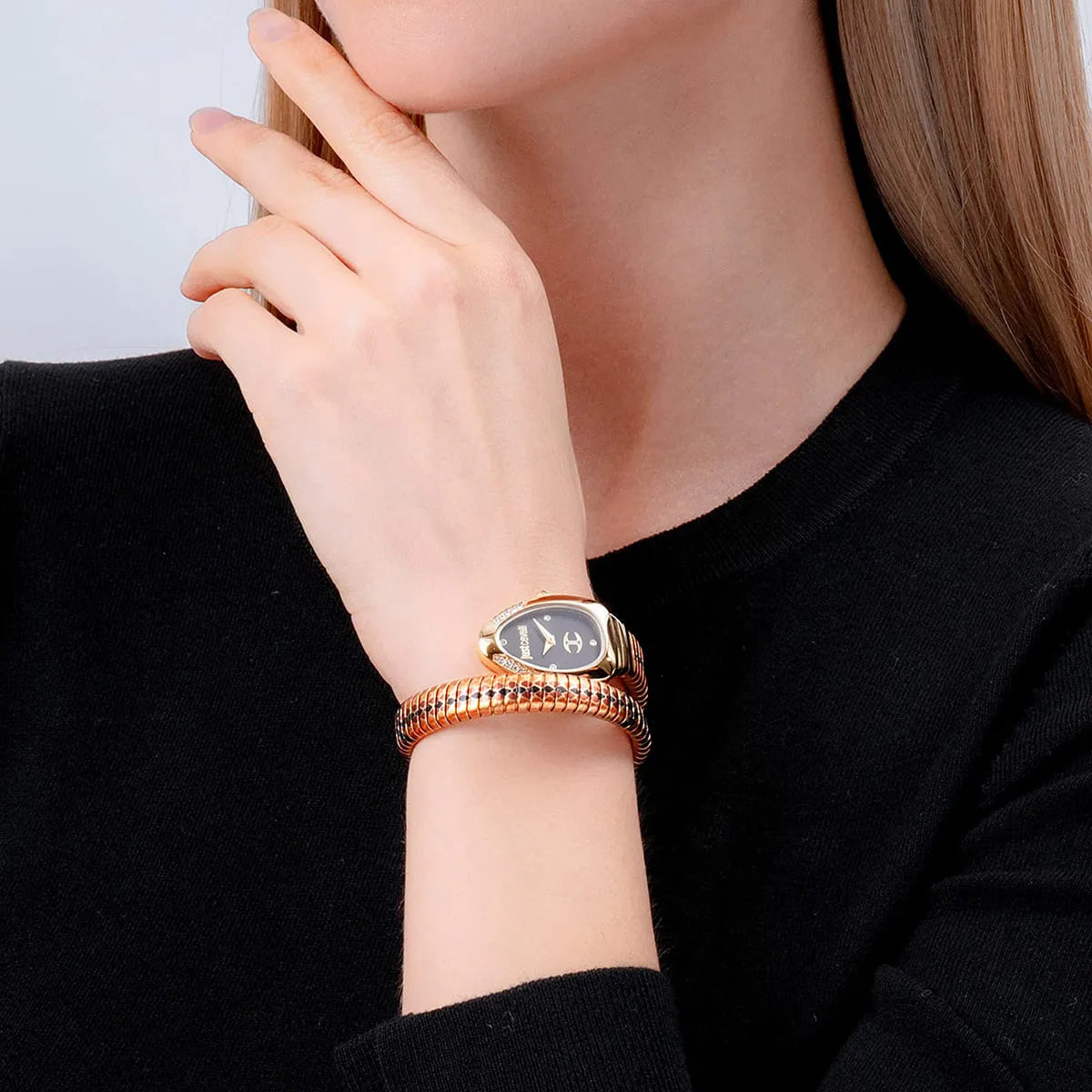 Woman wearing Just Cavalli snake-pattern wrap watch on wrist with gold case and crystals visible