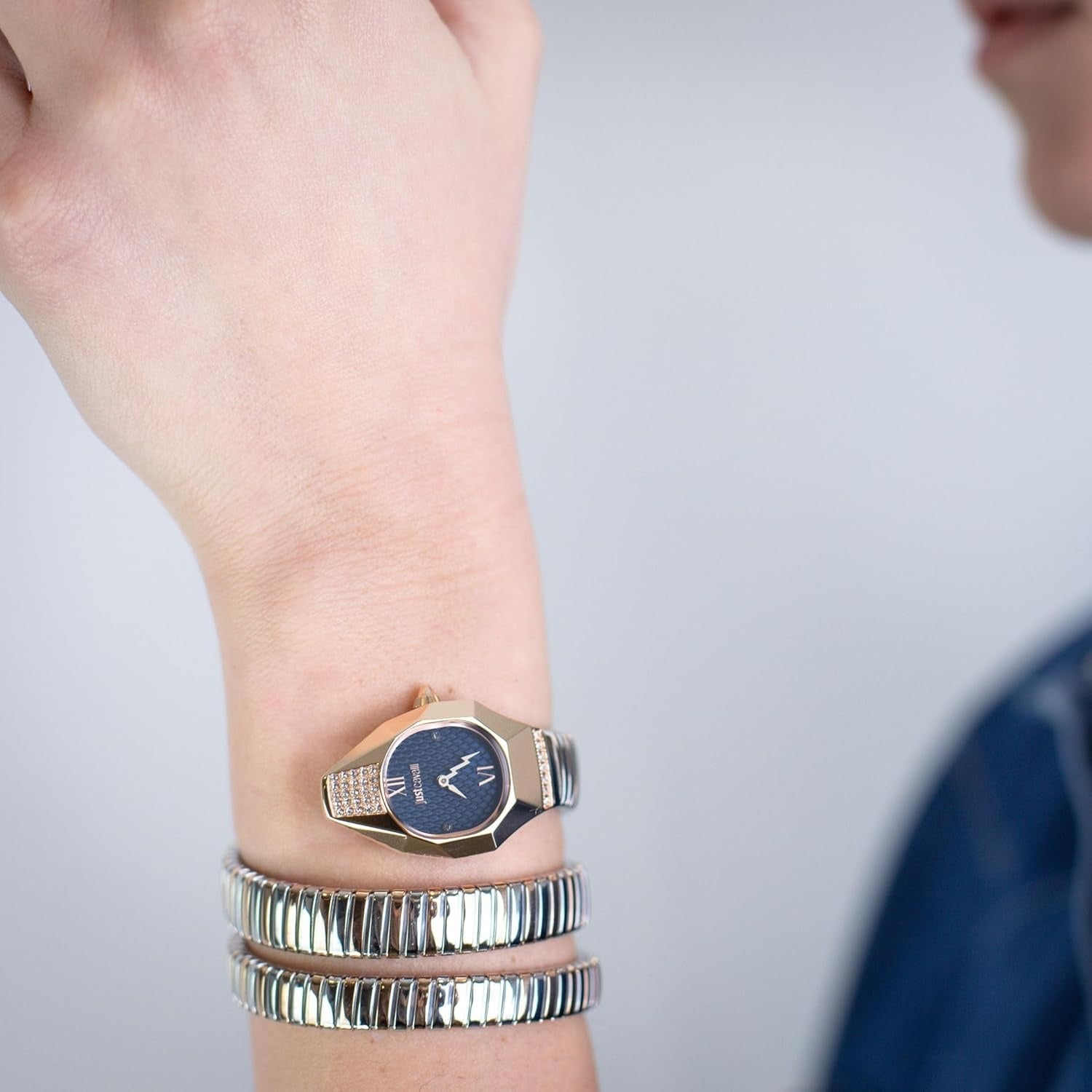 Just Cavalli Lunara watch worn on wrist with blue dial and crystal-accented rose gold case