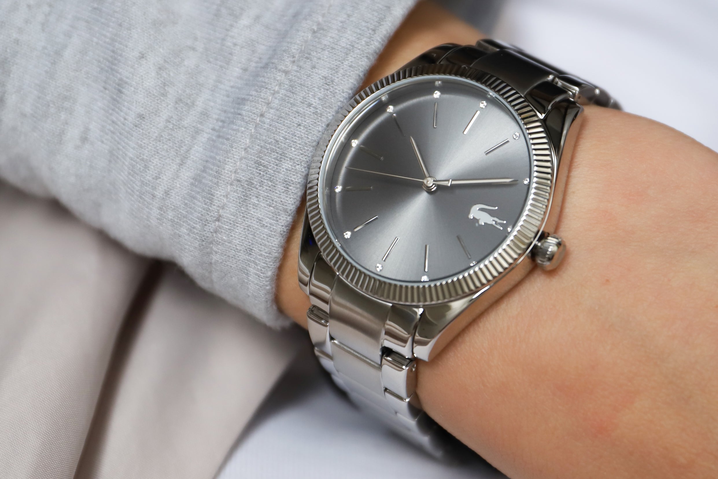 Lacoste 2001081 women's watch on wrist with grey dial and textured bezel detail