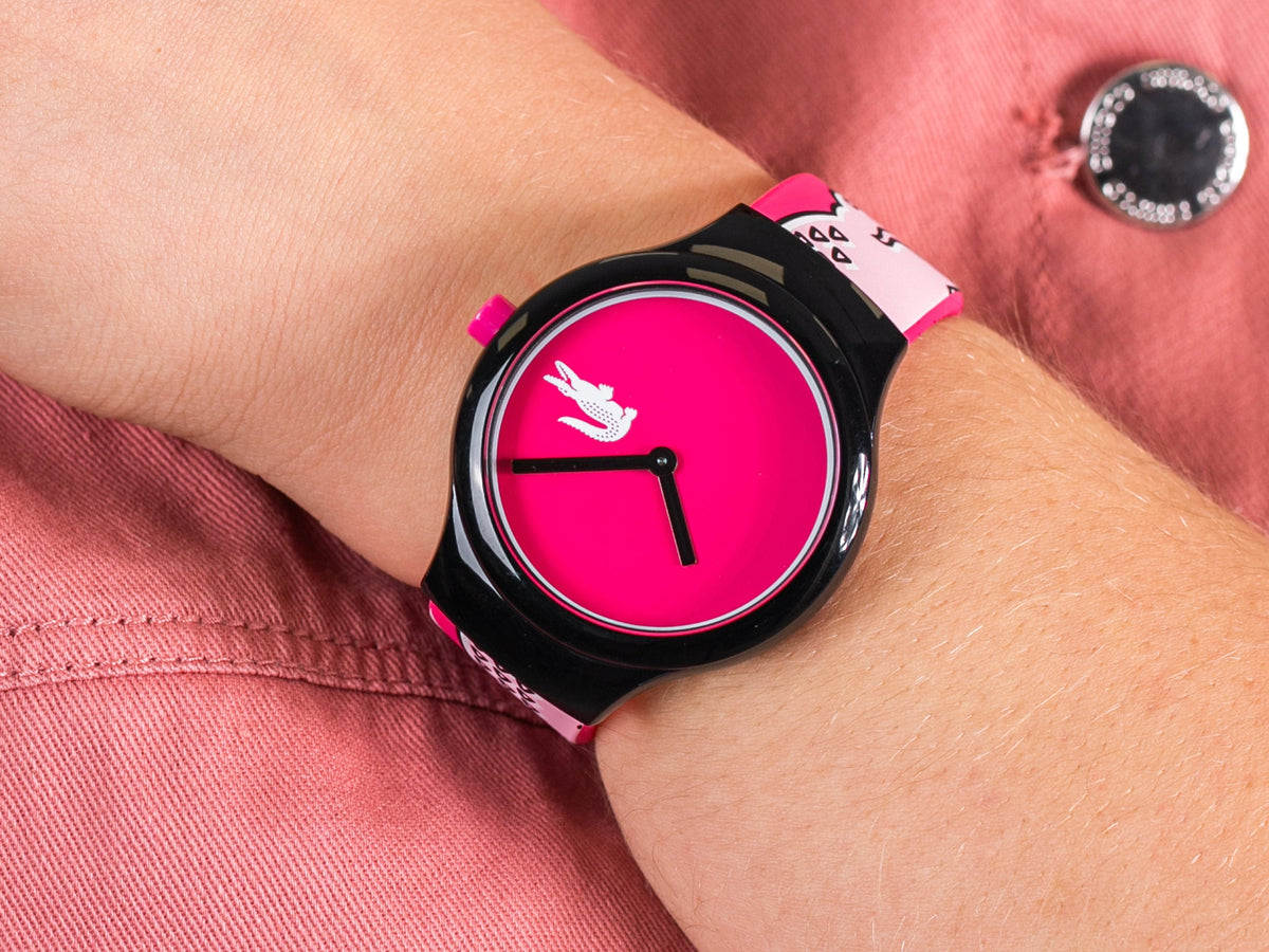 Lacoste Goa watch worn on wrist with pink dial and patterned strap visible