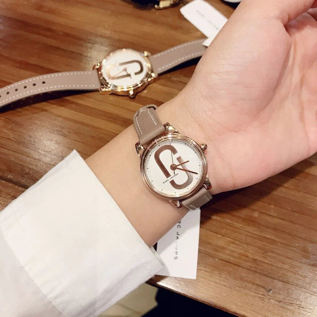 Marc Jacobs Corie women's watch on wrist with white dial and taupe leather strap