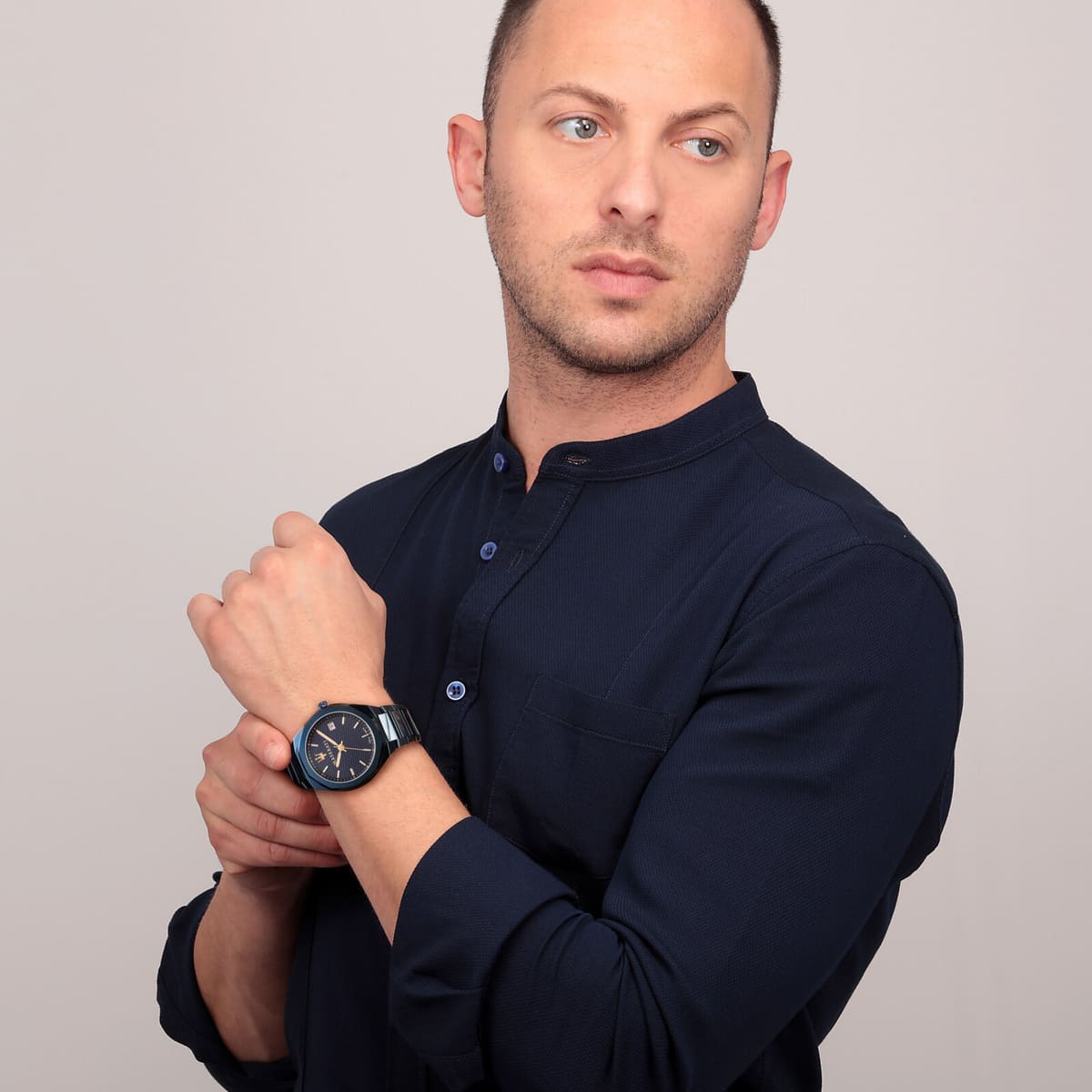 Maserati Blue Edition watch worn on wrist of man in navy button-up shirt