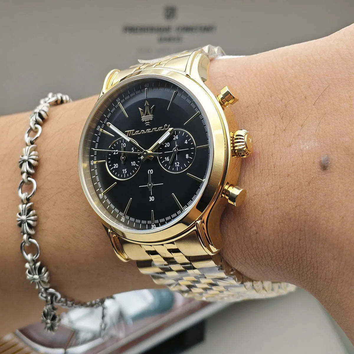 Maserati Epoca gold-tone watch on wrist showing black dial and bracelet