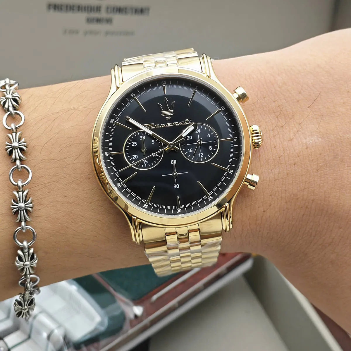 Maserati Epoca gold chronograph worn on wrist with black dial visible