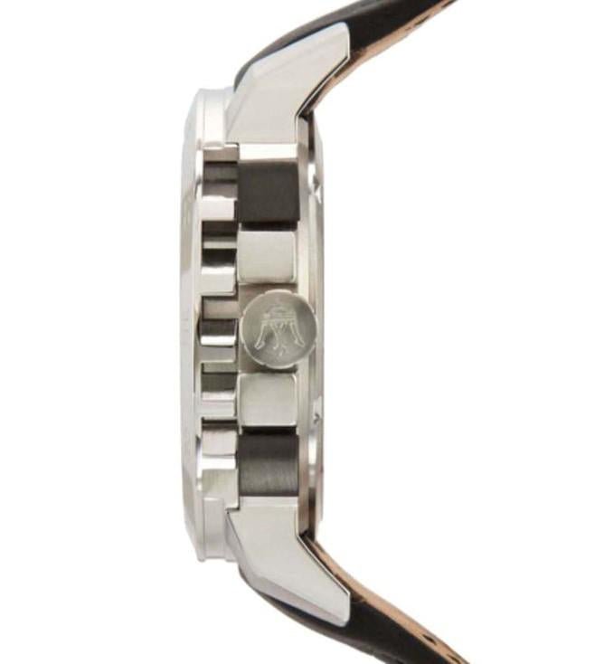 Side profile showing stainless steel case, black leather strap with tan lining, and chronograph pushers