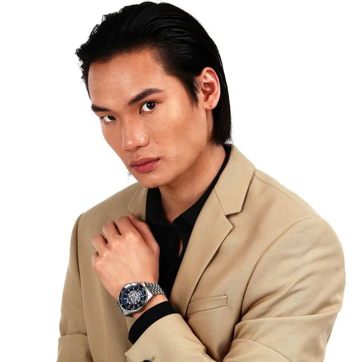 Man wearing Maserati Sfida automatic watch with blue dial and silver bracelet