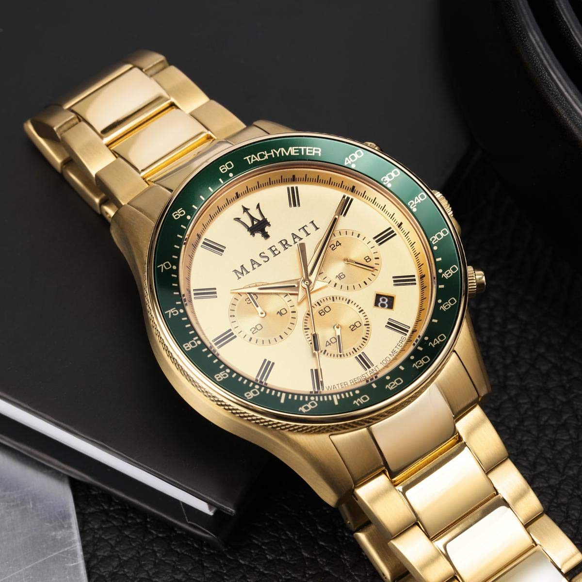 Maserati Sfida watch worn on wrist, displaying cream dial with chronograph subdials and gold bracelet