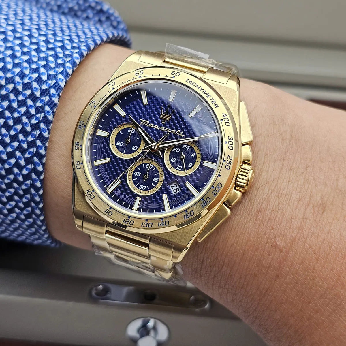 Maserati Velocità gold chronograph with blue dial on wrist