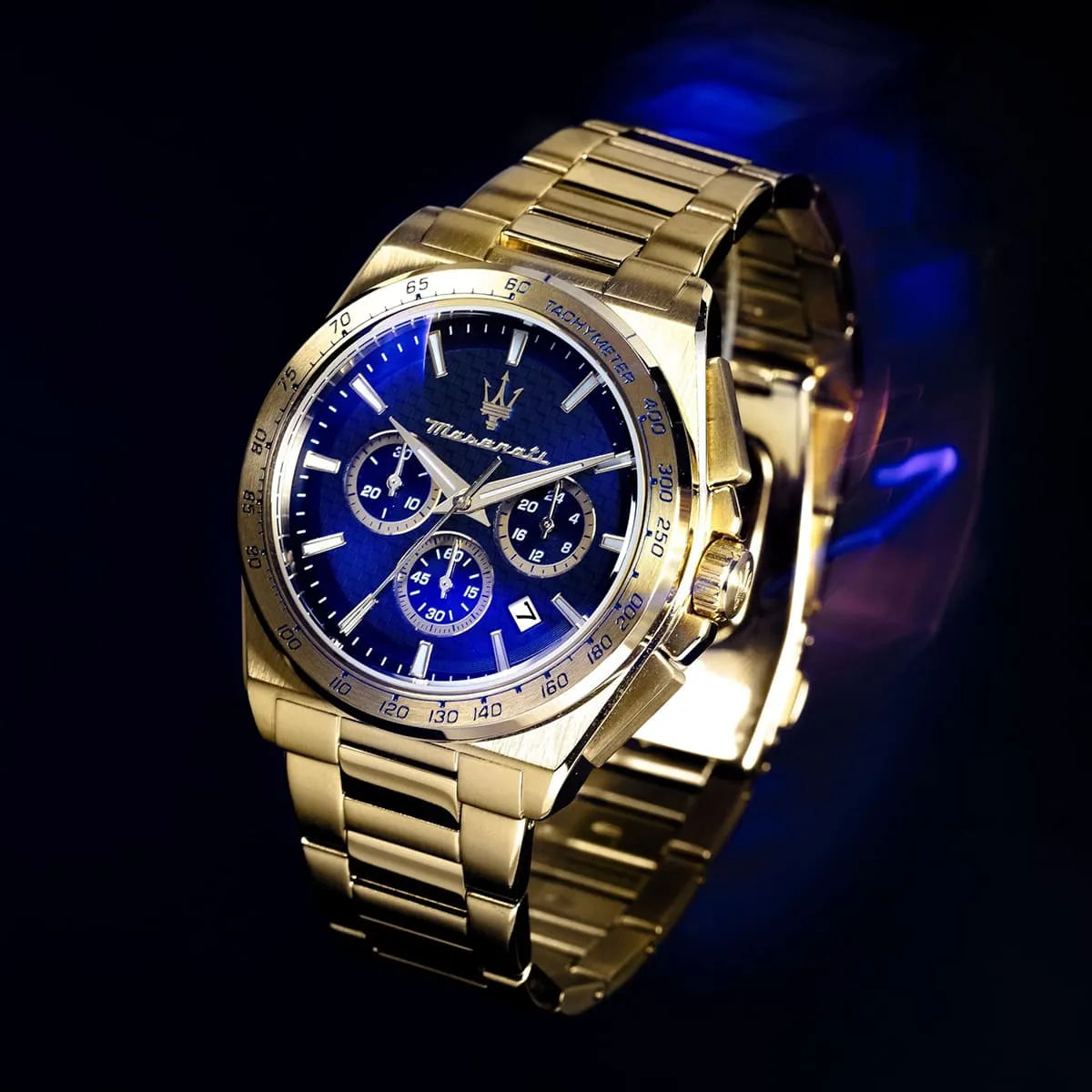 Maserati Velocità chronograph watch with blue dial and gold case on dark background