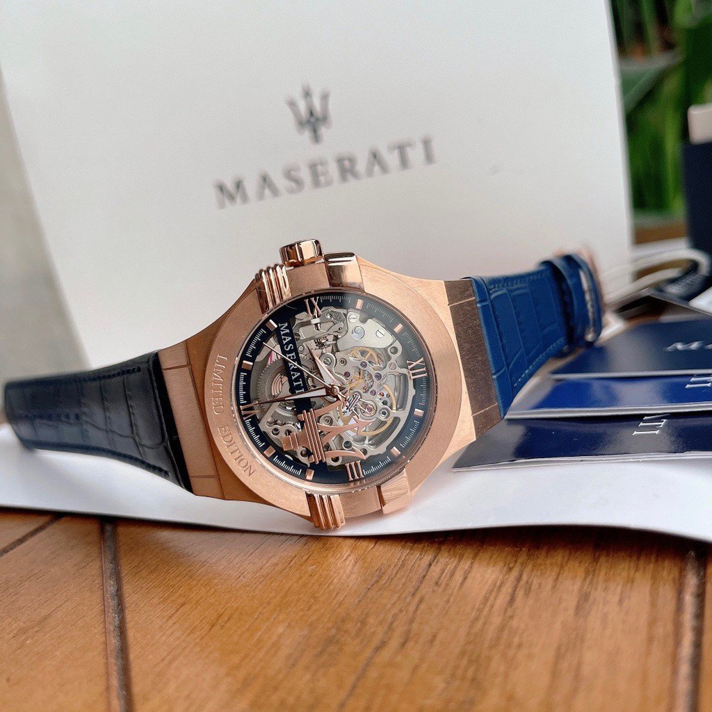 Side angle of Maserati skeleton watch showcasing rose-gold case and navy leather strap