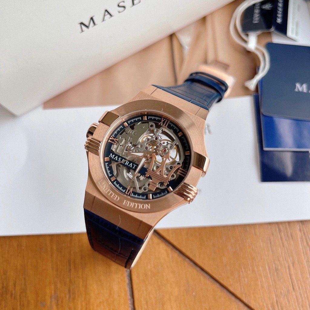 Angled view of Maserati skeleton watch with exposed mechanism and blue crocodile-style strap