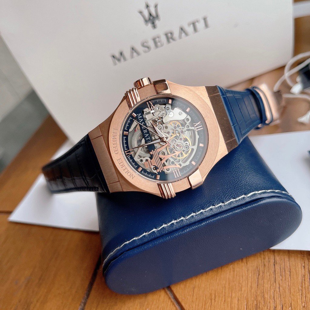 Maserati rose-gold skeleton watch displayed on blue presentation pillow box
