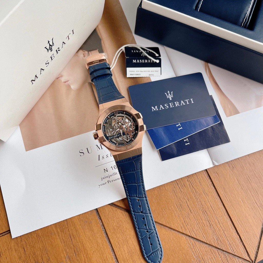 Maserati rose-gold skeleton watch on wrist with packaging and documentation