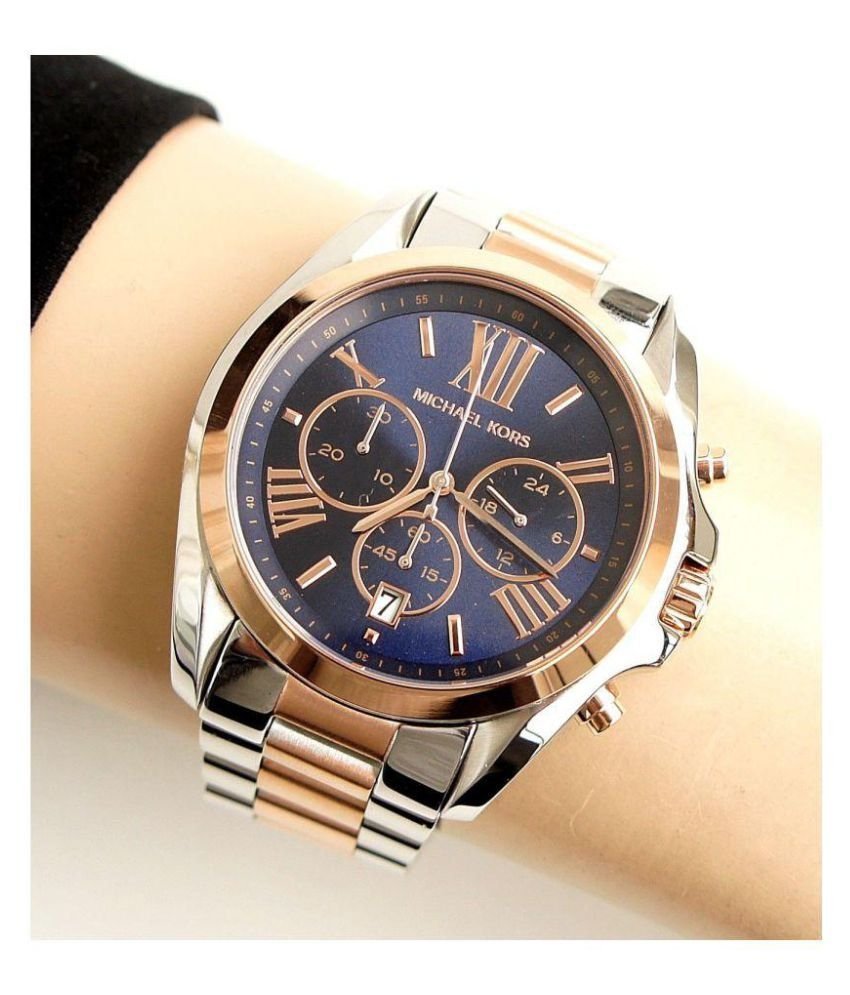 Michael Kors Bradshaw chronograph watch worn on wrist showing blue dial and dual-tone bracelet