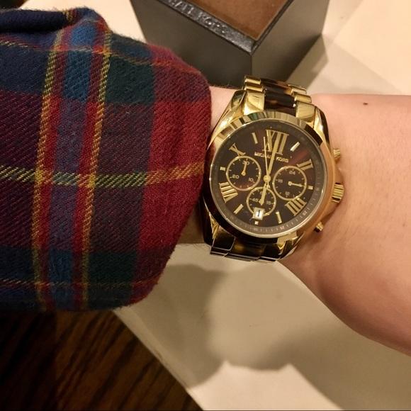 Michael Kors Bradshaw MK5696 chronograph watch worn on wrist with plaid sleeve