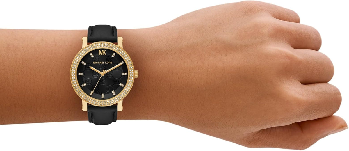 Michael Kors Corey three-hand watch worn on wrist with black leather strap
