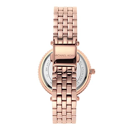 Rose gold watch caseback showing metal strap and crystal-set bezel