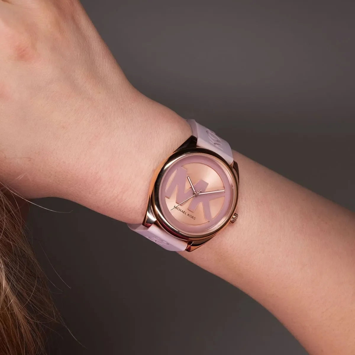 Michael Kors Janelle watch worn on wrist showing rose dial and pink strap
