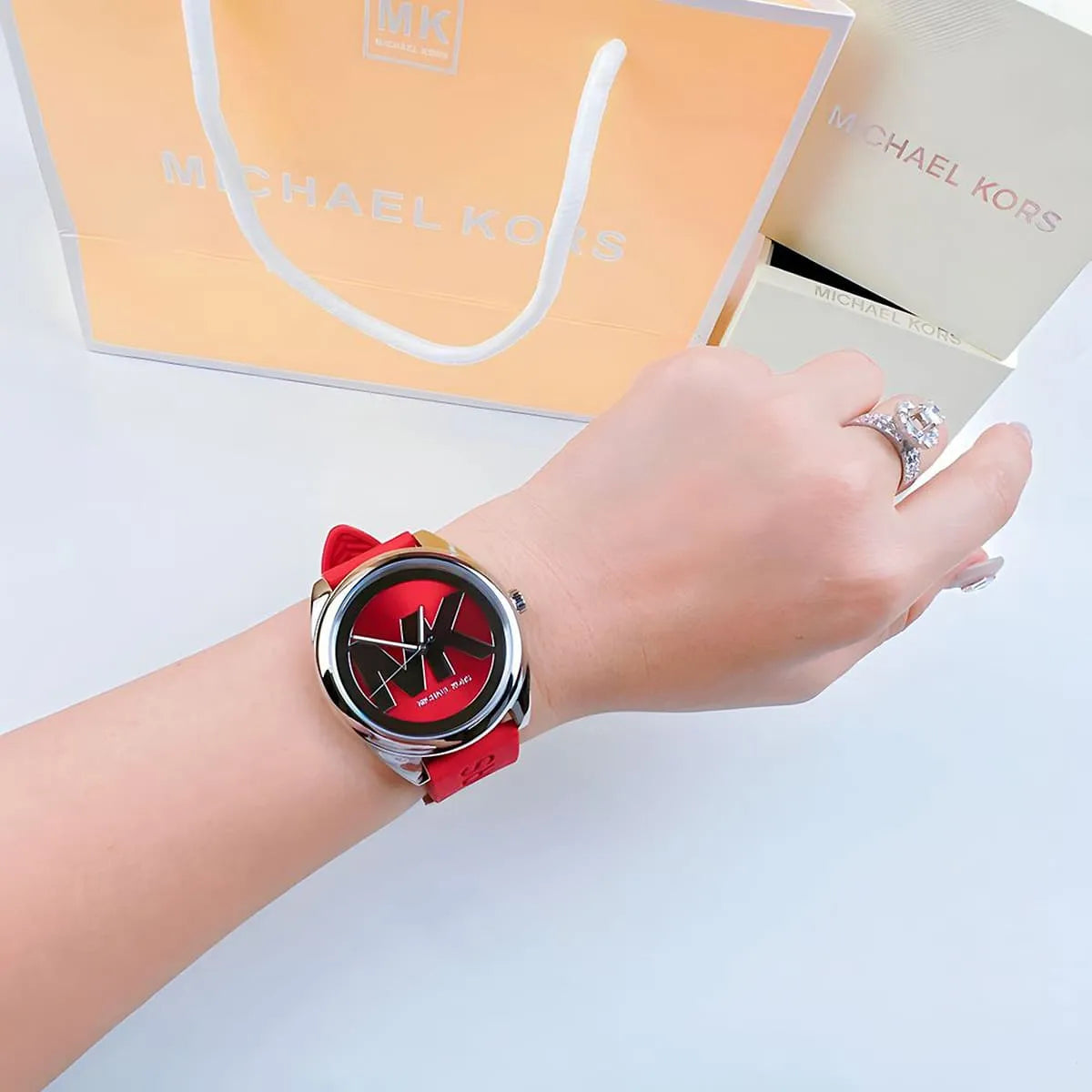 Michael Kors Janelle watch on wrist with shopping bag and packaging visible