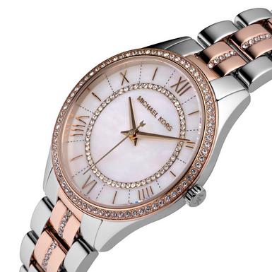 Michael Kors Lauryn watch worn on wrist displaying white dial and rose gold and silver design