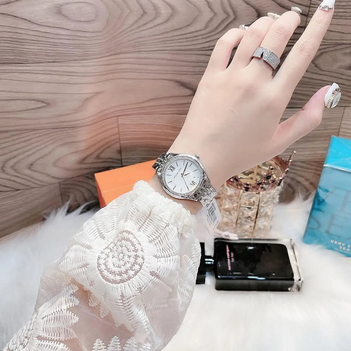 Michael Kors Mindy MK7075 watch worn on wrist showing crystal-embellished bezel and bracelet