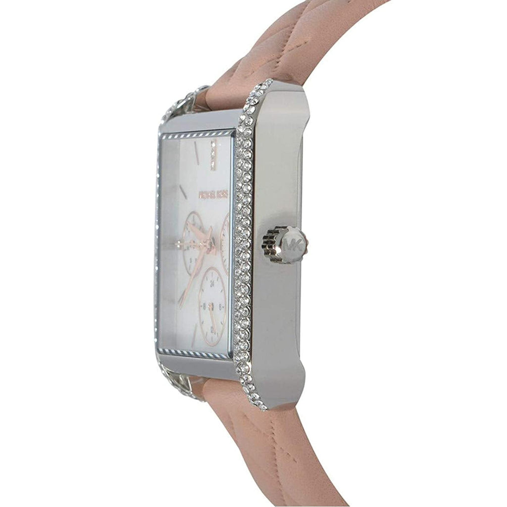 Michael Kors Drew watch on wrist showing rectangular crystal-set case and pink leather strap