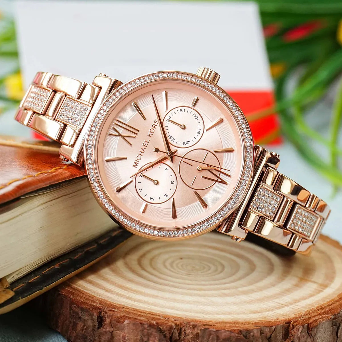 Michael Kors MK4354 Sofie chronograph watch on wrist with wood and flower background