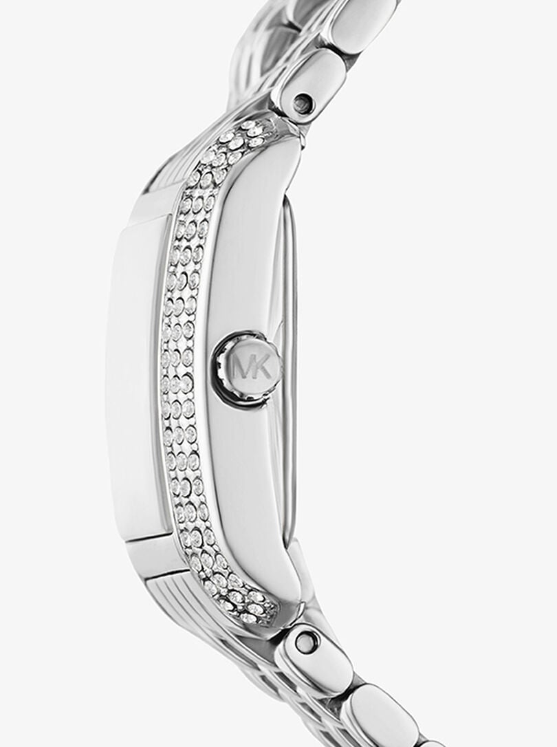 Side profile of silver-tone watch case with crystal-pavé bezel detail