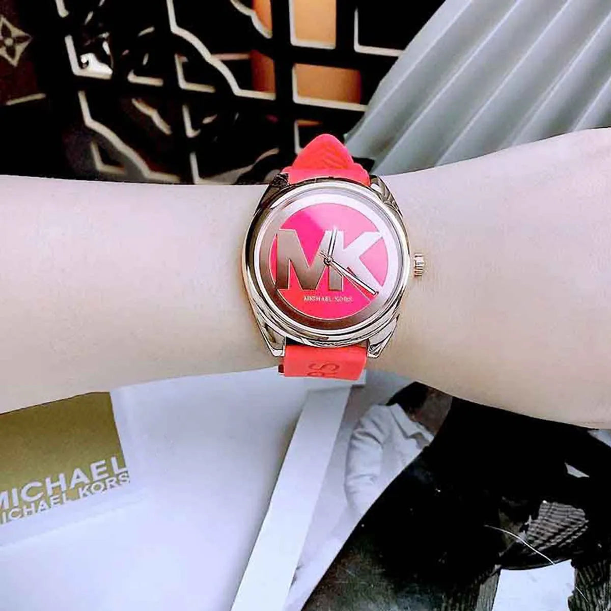 Michael Kors Janelle watch worn on wrist showing red dial and red rubber strap